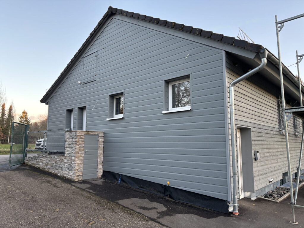 Einstöckiges Haus mit grauer Dielen Verkleidung